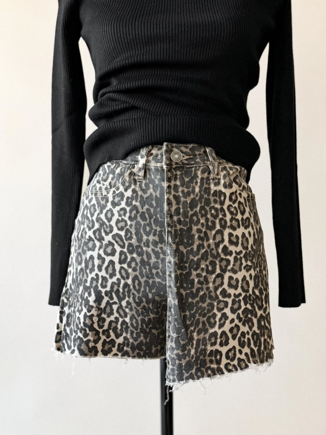 Black sweater with leopard print shorts on a white background