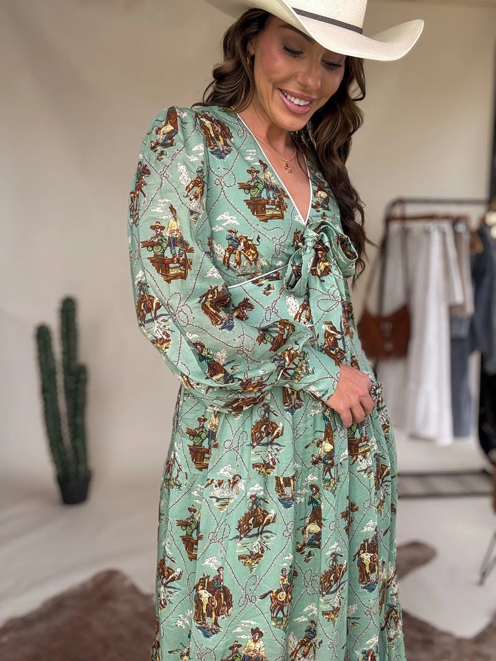 Woman in green western print dress and cowboy hat, western boho outfit, boutique style