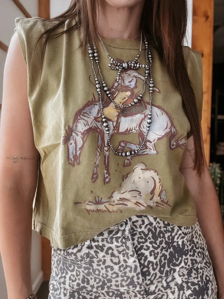 Person wearing a sleeveless green top with a graphic design of a horse and rider, layered with necklaces.