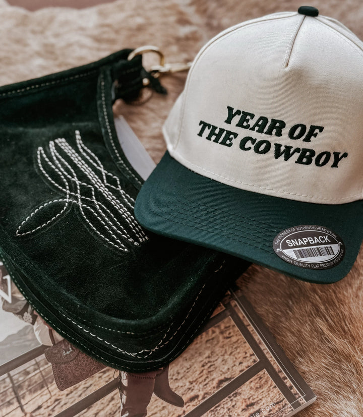 Year of the Cowboy snapback hat with cactus purse on cowhide, western style accessories