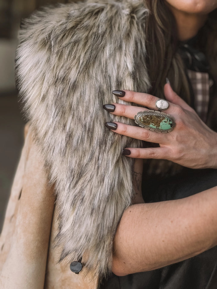 Woman wearing faux fur western vest and turquoise statement ring, western boho style