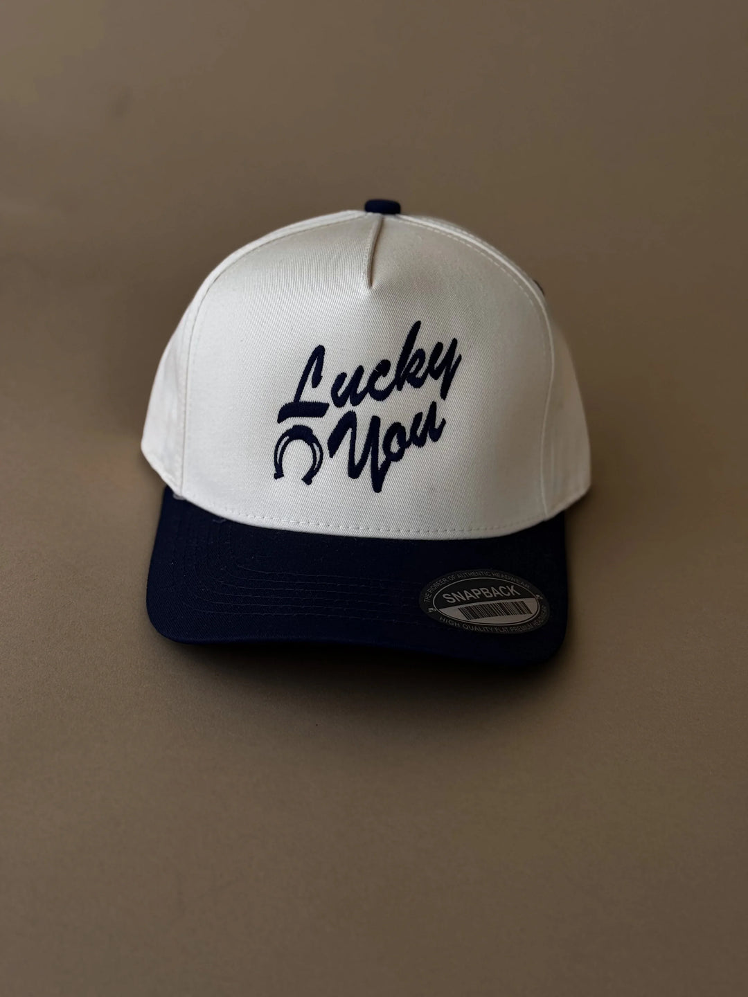 White and navy western snapback hat with &