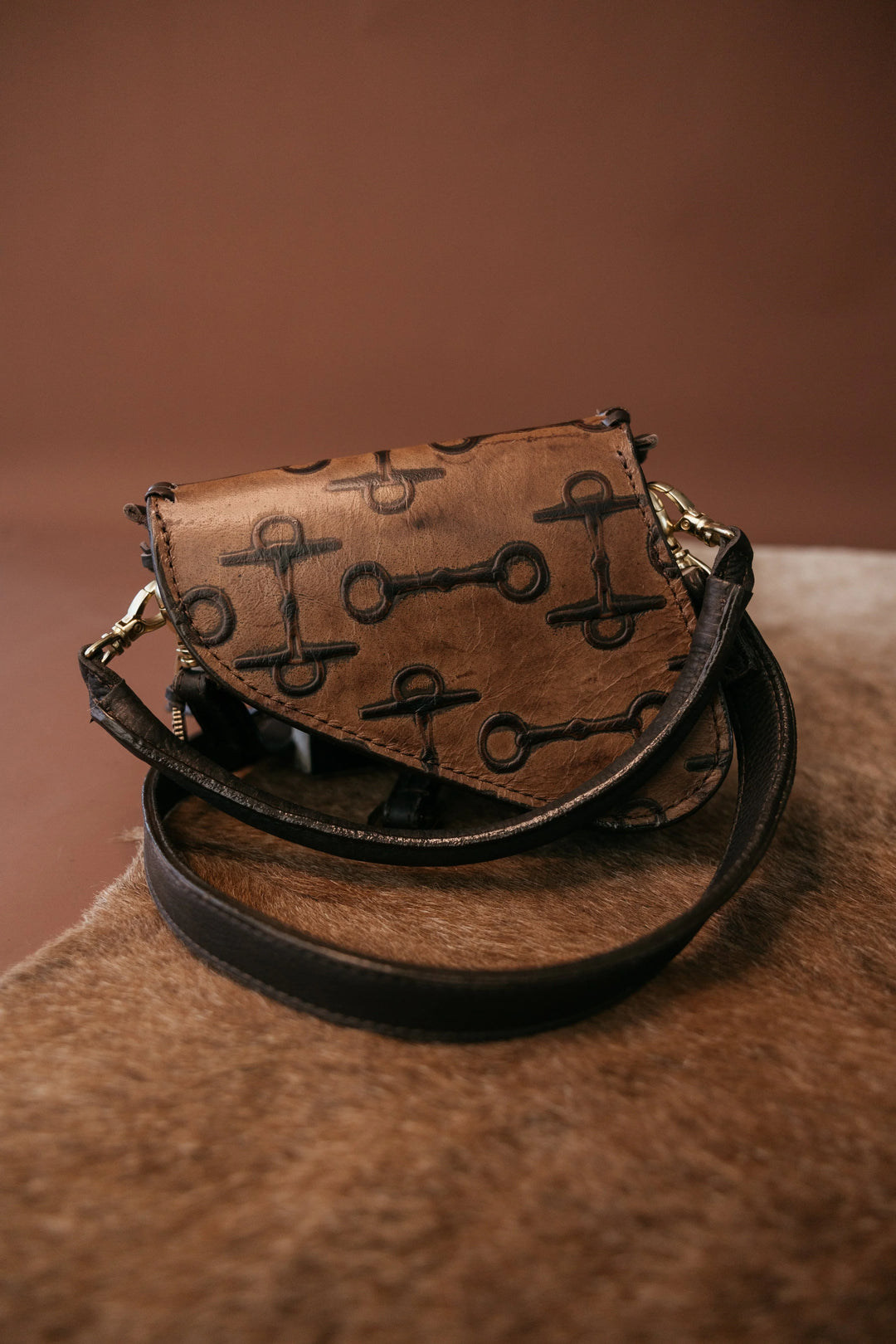 Brown leather bag with key patterns on a brown background