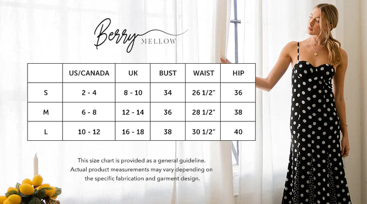 Woman in a polka dot dress standing next to a size chart with measurements.