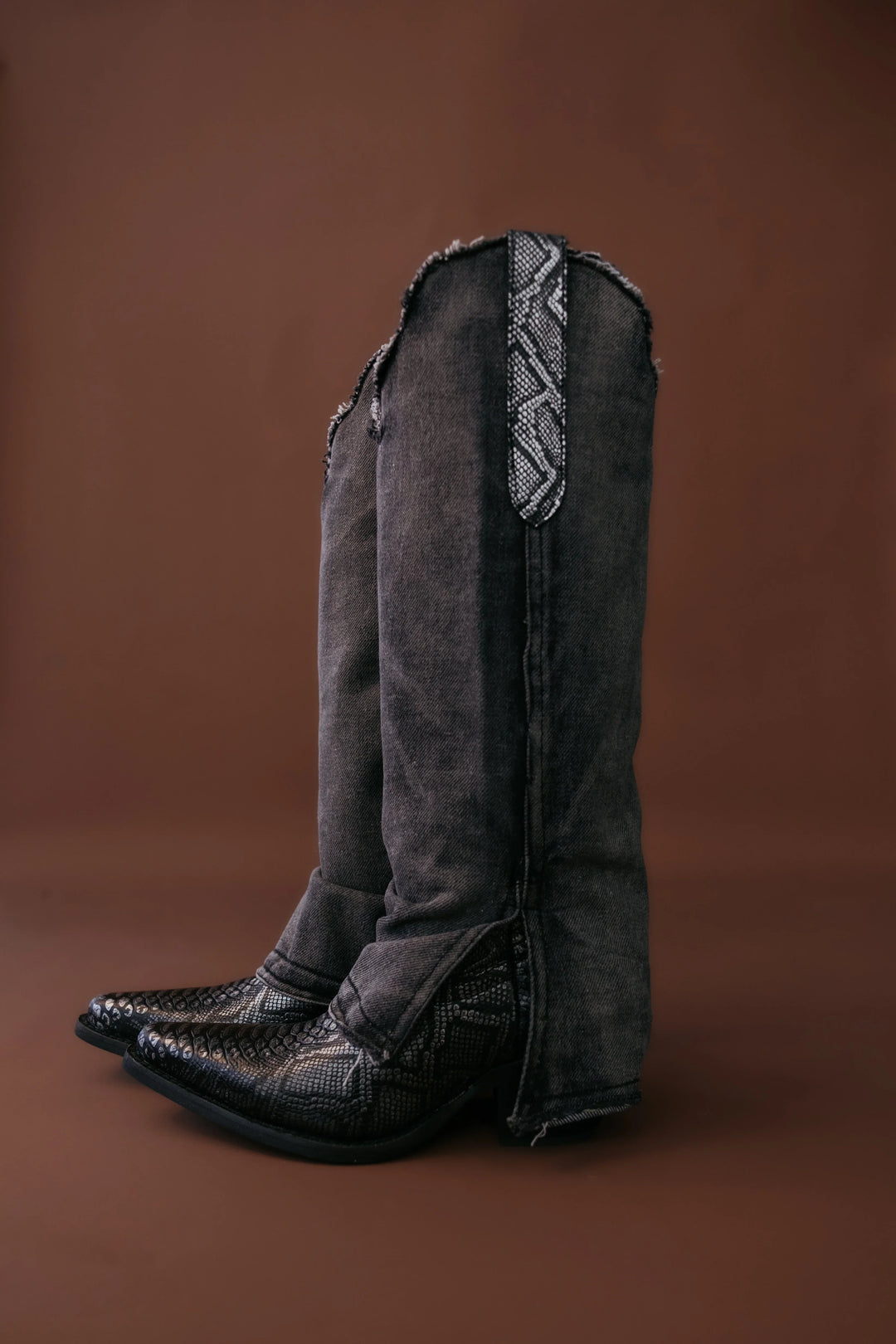 Black western boots with denim flare pants and snakeskin detail, cowgirl boho style