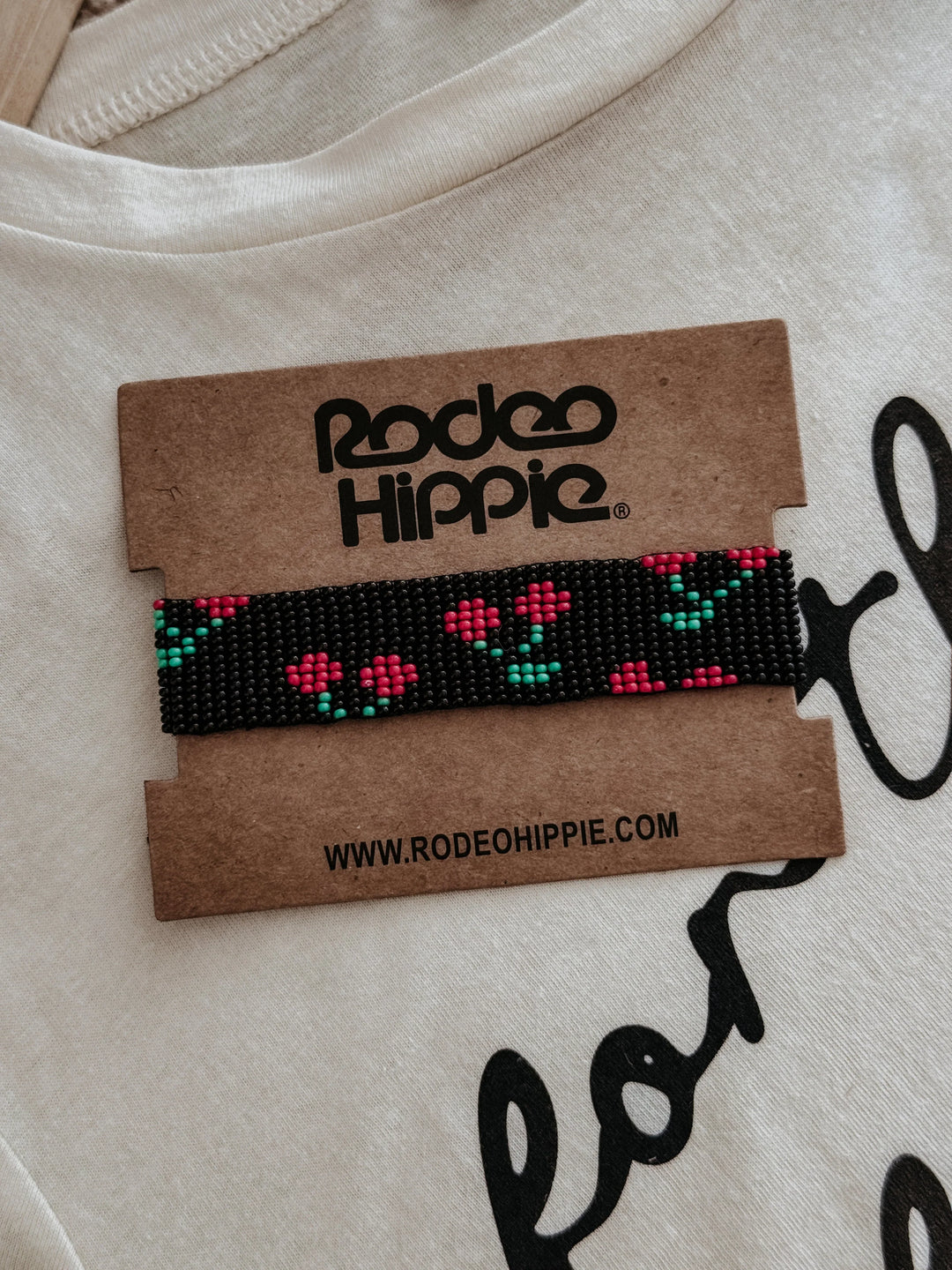 cherry Beaded bracelet on a Rodeo Hippie branded card with a beige background